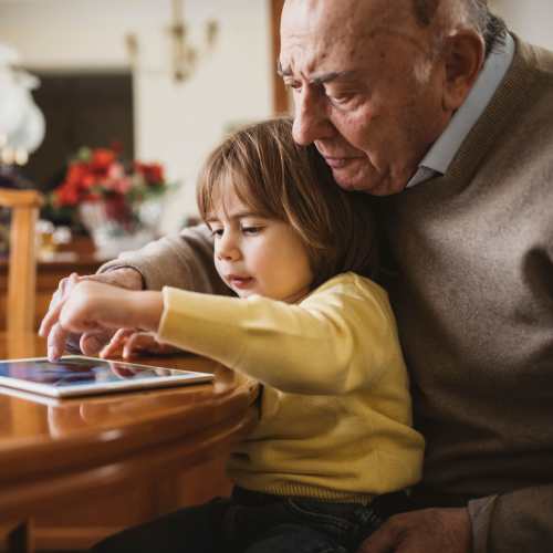 Resident spending time with their grandchild at Pines of Newmarket in Newmarket, New Hampshire