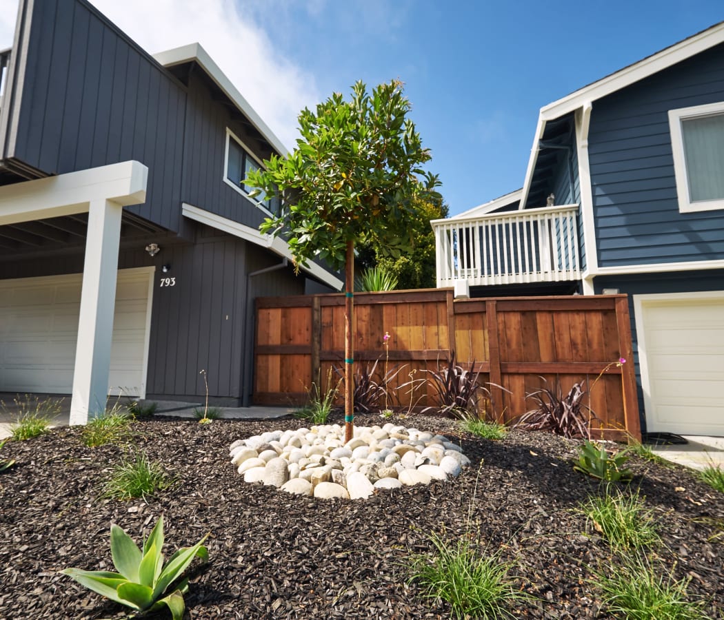 Spacious deck  and a beautifully manicured front yard at Santa Cruz Coast Homes in Santa Cruz, California