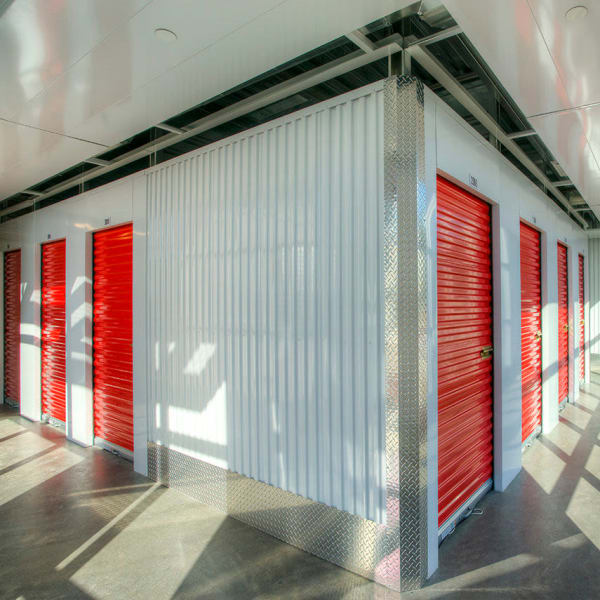 Indoor storage units with bright doors at StorQuest Express Self Service Storage in Seffner, Florida