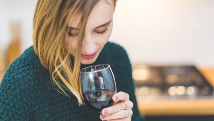 Woman enjoying glass of red wine at Texas Sun Winery near Anatole on Briarwood in Midland, Texas