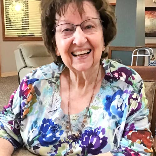 A resident smiling at Glen Carr House Memory Care in Derby, Kansas