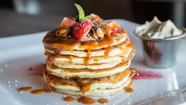 Plate of fruit-covered pancakes at a restaurant near Olympus 7th Street Station in Fort Worth, Texas