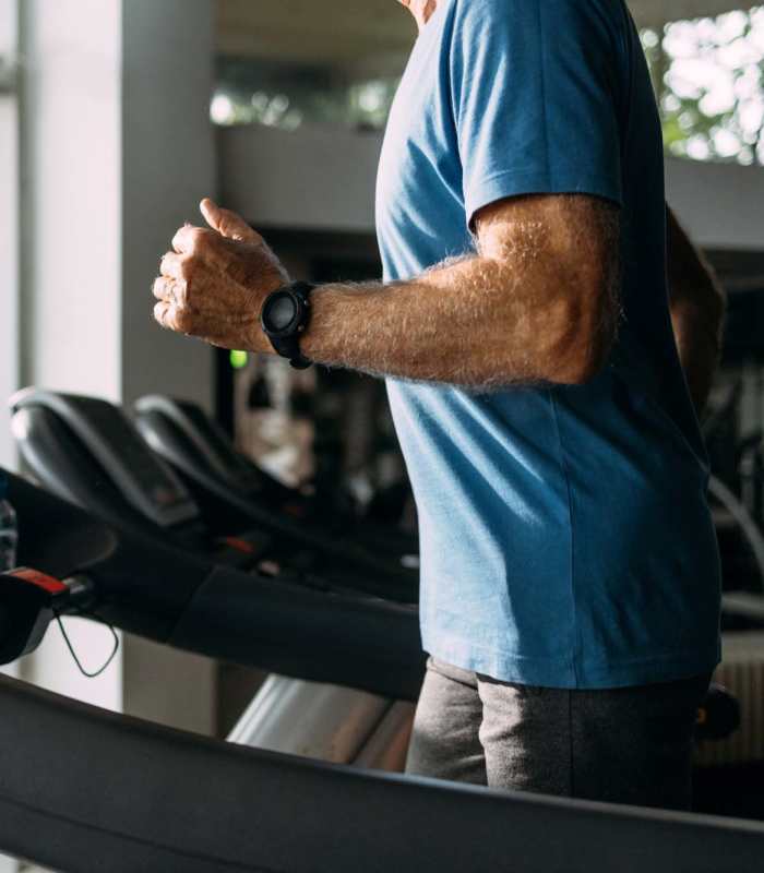 Resident working out in the gym at Woodfield Heights Apartments in Waukesha, Wisconsin