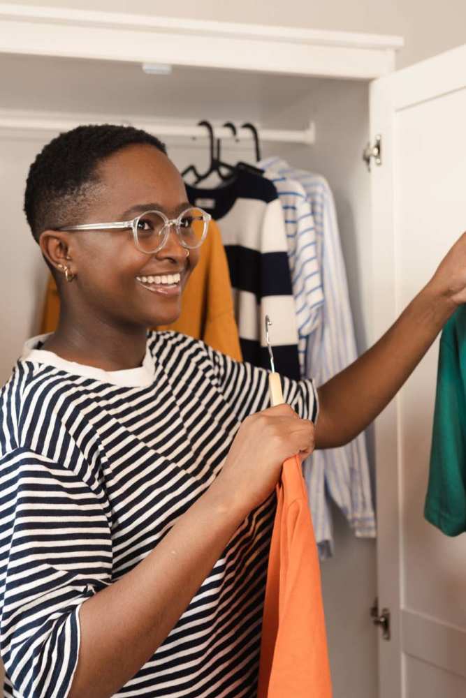 Woman picking clothes from her walk-in closet at Icon Apartments in San Antonio,Texas