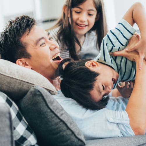 a family laughing together at Davis Hill in Joint Base Lewis McChord, Washington