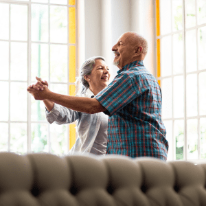 Two residents dancing in a lounge at Atlas Point at Prestonwood in Carrollton, Texas