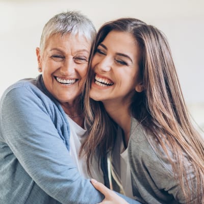 Mother and daughter smiling with each other at The Sanctuary at West St. Paul in West St. Paul, Minnesota