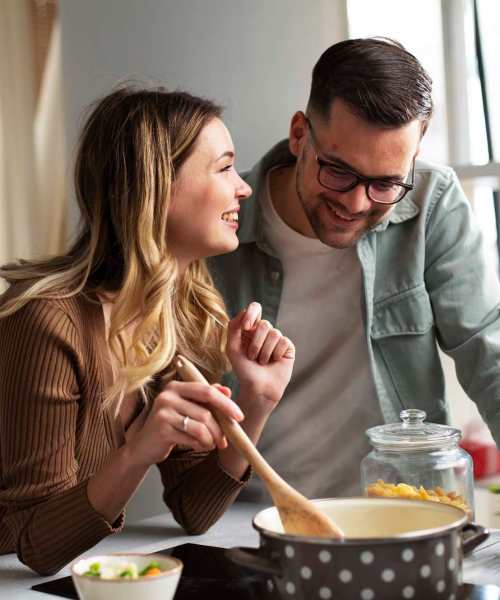 Happy couple in their apartment kitchen at Gateway Terrace Apartments in Sun Prairie, Wisconsin