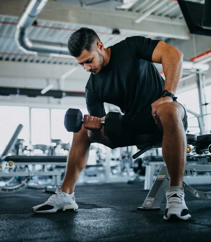 Resident lifting barbell weights at Edge at Concord in Concord, North Carolina