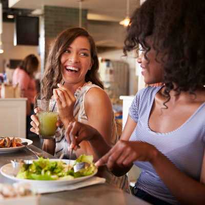 Two friends out for lunch in a restaurant at Westmont Village in Charlotte, North Carolina