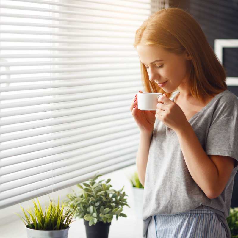 Resident drinking coffee at Villa Escondido in Orange Cove, California