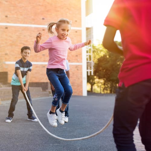 Kids jumping rope at a school near Beach Court Apartments in Seattle, Washington