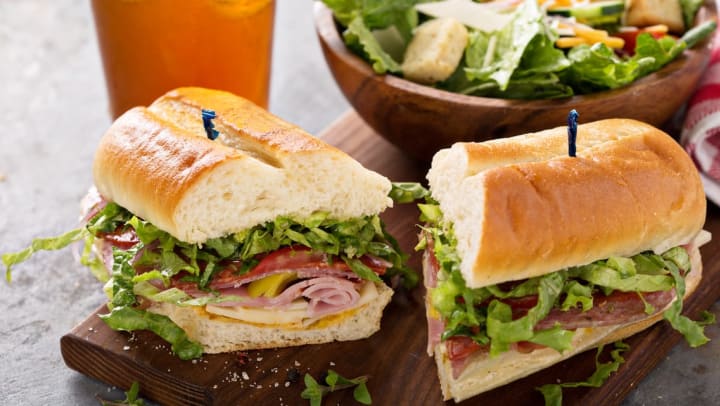 Italian deli sandwich with salad and drinks on the side | Sarasota delis