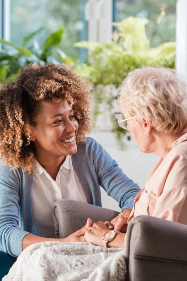 Resident receiving help from a caregiver at Merrill Gardens at Barkley Place in Fort Myers, Florida