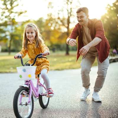 A resident teaching his daughter to ride bike near Weston Reserve Apartments, Morrisville, North Carolina