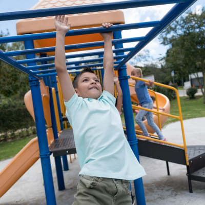 A child playing on a playground at Harborview in Oceanside, California