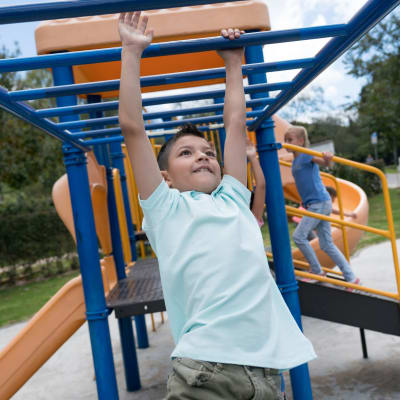 A child playing on a playground at Olympic Grove in Joint Base Lewis McChord, Washington