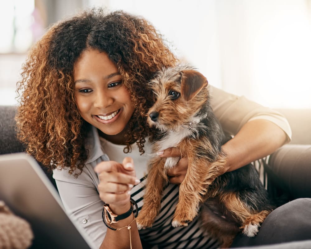 A resident holding a dog in a home at Silver Strand I in Coronado, California