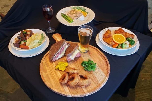 Meal options including mashed potatoes and steak, a Reuben sandwich with onion rings, seared tuna with asparagus, fried chicken and vegetables at Legacy Living Florence in Florence, Kentucky