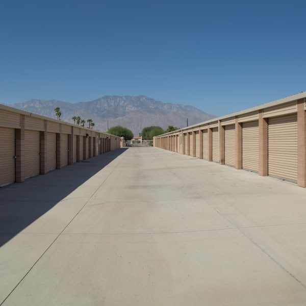 Outdoor storage units with tan doors at StorQuest Self Storage in Cathedral City, California