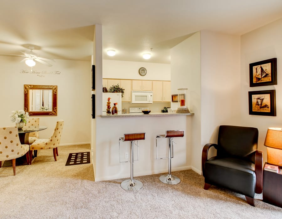 Kitchen with a breakfast bar over looking the living room at The Dakota Apartments in Lacey, Washington