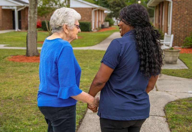 Resident friends walking on the grounds at Truewood by Merrill, Glen Riddle in Glen Riddle, Pennsylvania
