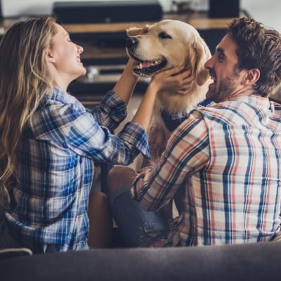 A couple playing with their dog at Osprey Point in Virginia Beach, Virginia