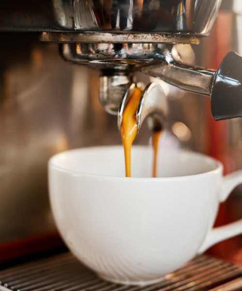 Espresso machine filling a cup with coffee near Shea Ravines in Wyoming, Michigan