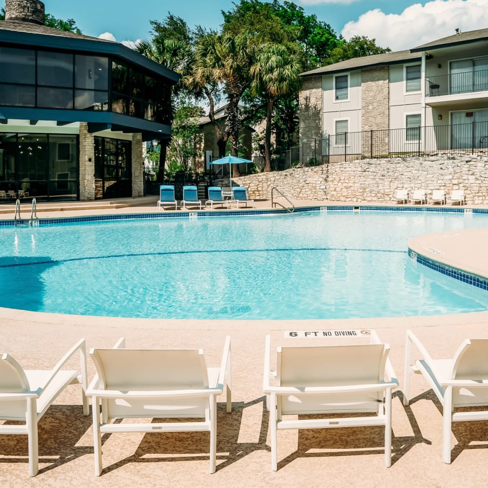 Large pool with poolside lounge chairs at Pearl Park in San Antonio, Texas