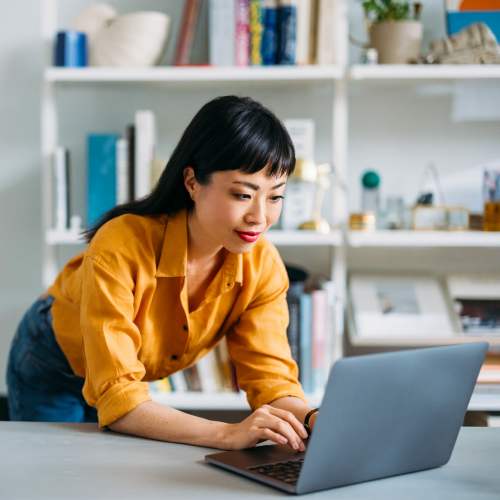 Resident woman working on her laptop at Cresta Bella in San Diego, California