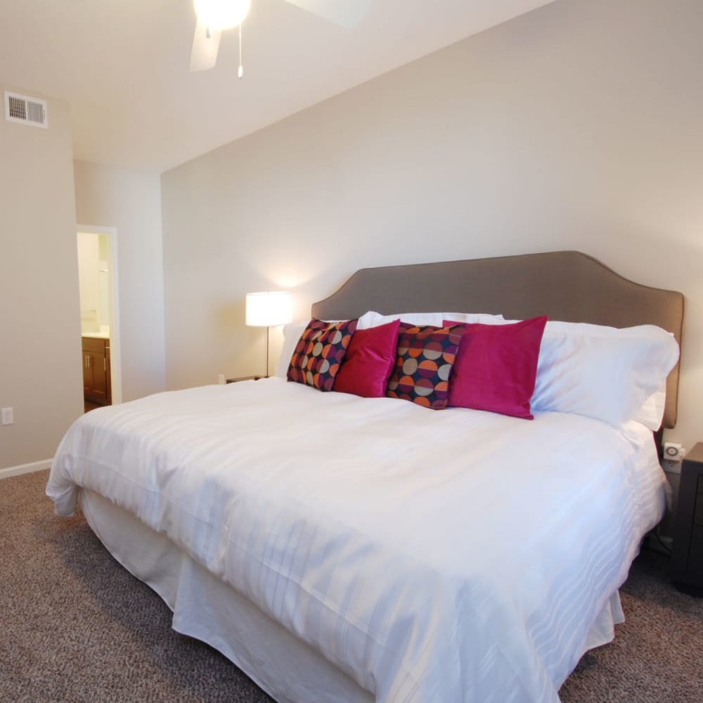 Cozy bedroom with carpet at Oaks Centropolis Apartments in Kansas City, Missouri
