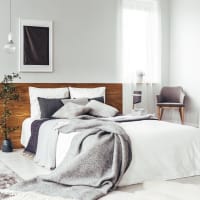 Modern furnishings in a model apartment's primary bedroom at Chateau Woods in Woodinville, Washington