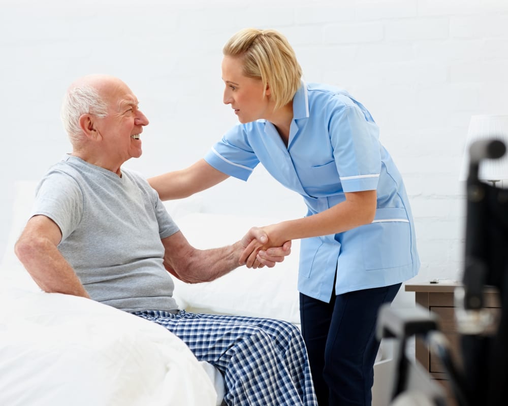 Staff helps resident out of bed at Holstein Senior Living in Holstein, Iowa.