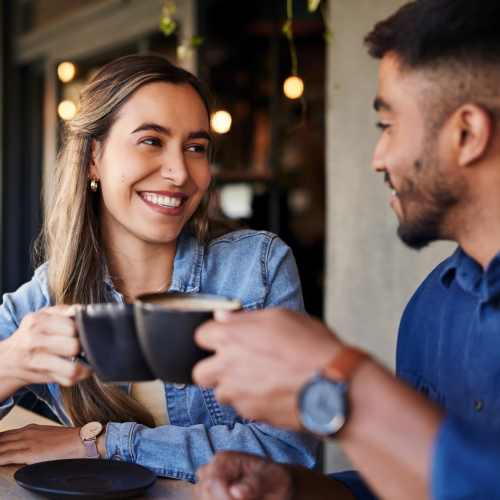 Woman having coffee with her friend at The Courtyards Pacific Village in San Diego, California