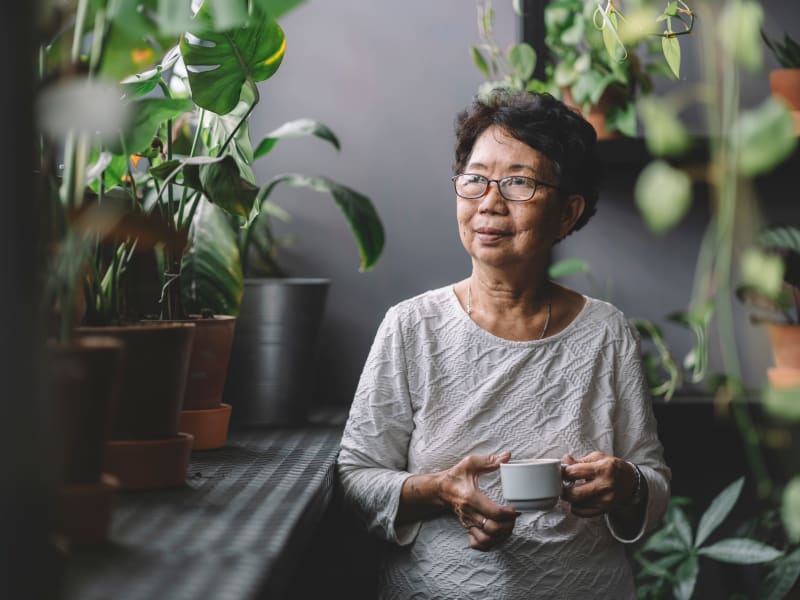 A resident enjoying a cup of tea at Honeysuckle Senior Living in Hayden, Idaho. 