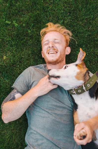 Resident and his dog resting in the park after a run near The Reserve at Johns Creek Walk in Johns Creek, Georgia