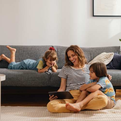 Happy family of 3 in the living room at Schroeder Square Apartments in Madison, Wisconsin