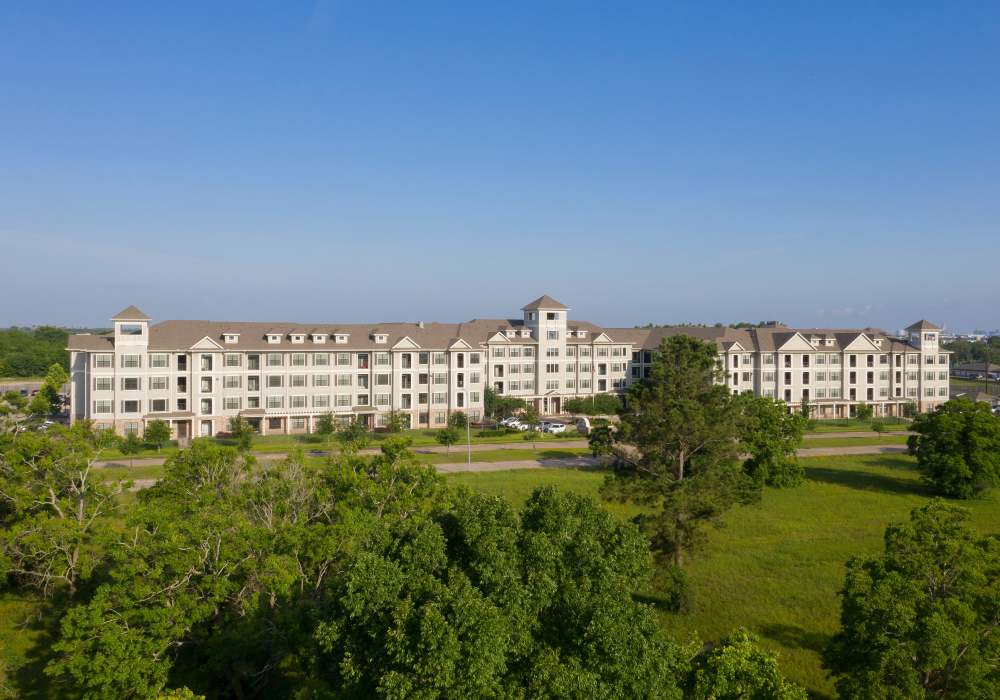 Exterior view of the apartments with trees and garden at Nantucket at Fannin Station in Houston, Texas