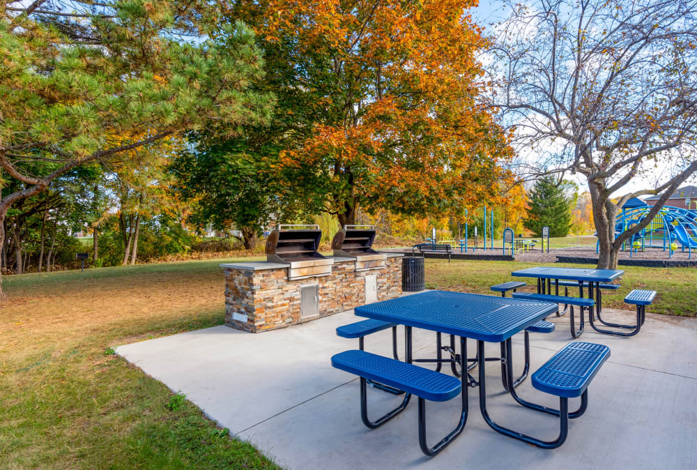 Grilling area with picnic tables at Waverlywood Apartments & Townhomes in Webster, New York