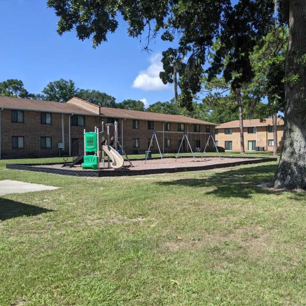 Outer view of apartment and play area at Caroline Arms in Jacksonville, Florida