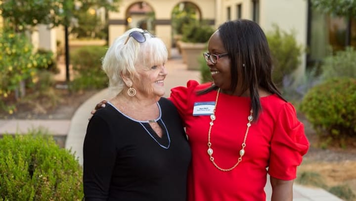 Smiling resident and team member at Merrill Gardens