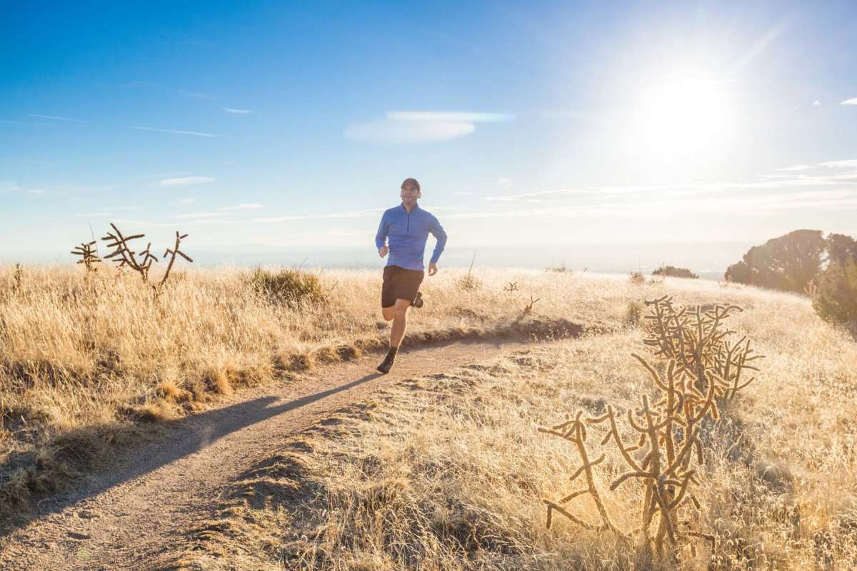 Residents out for a run near Acacia at Youngtown in Youngtown, Arizona