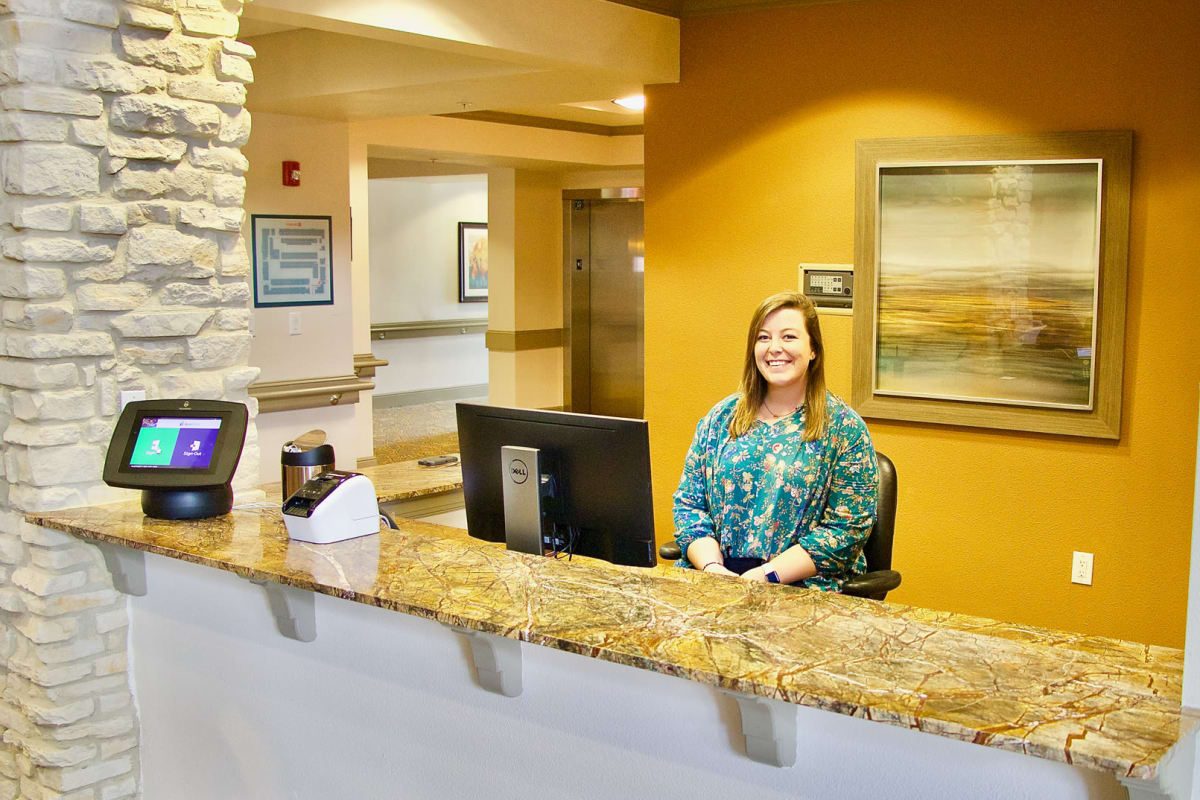 Resident at the front desk of Isle at Watercrest Mansfield in Mansfield, Texas