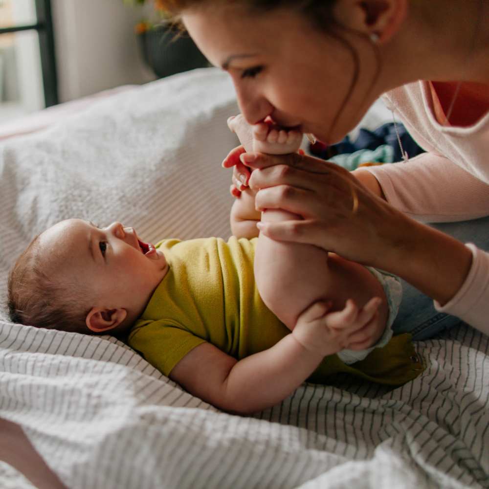 Baby with her mother in bedroom at The Flats Of Donelson in Nashville, Tennessee