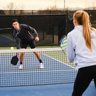 Residents playing tennis near The Seven At West Boca in Boca Raton, Florida