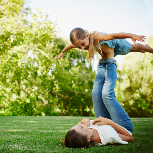 A mother and her daughter playing in a yard at El Centro New Fund Housing (Officers) in El Centro, California