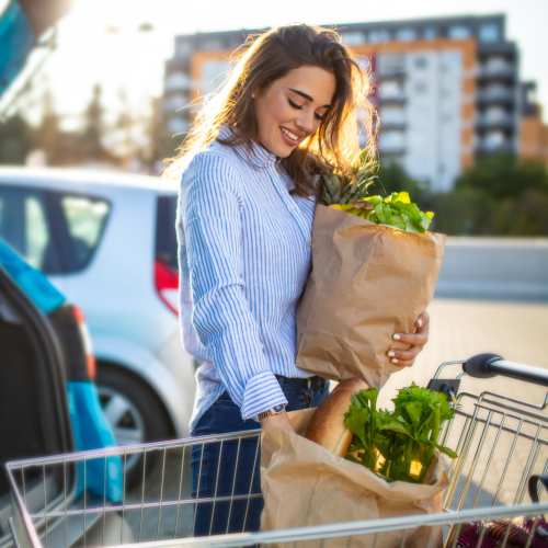 Resident woman with a shopping cart near The Olivia in Homestead, Florida