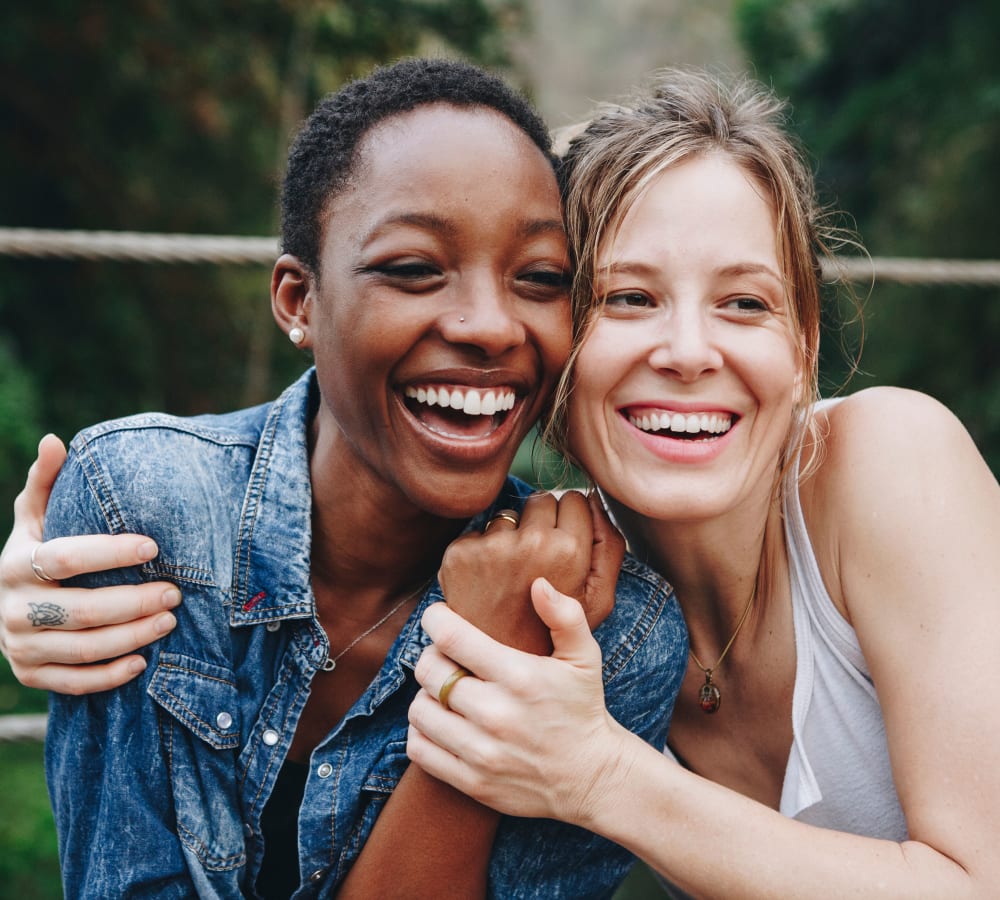 Two women smiling and embracing at Brighton Park in Byron, Georgia