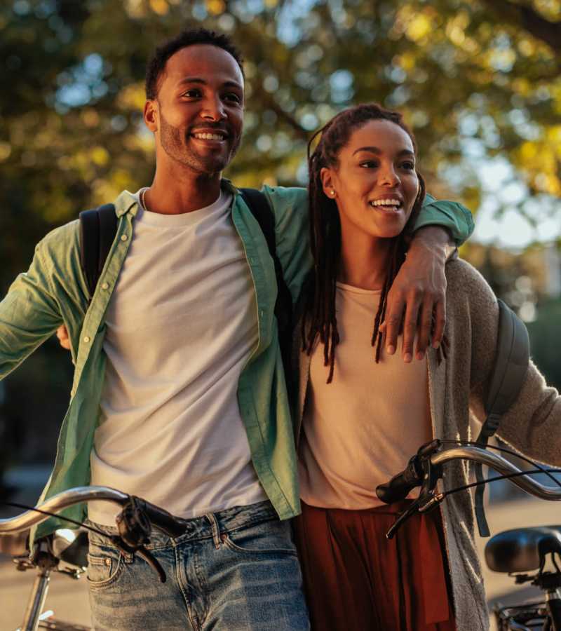 A happy couple riding their bikes at Sacramento, California, apartments at Waters Edge