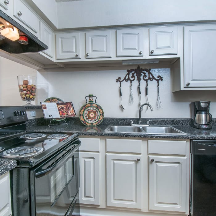Modern kitchen with black appliances in model home at Grayson Ridge in North Richland Hills, Texas